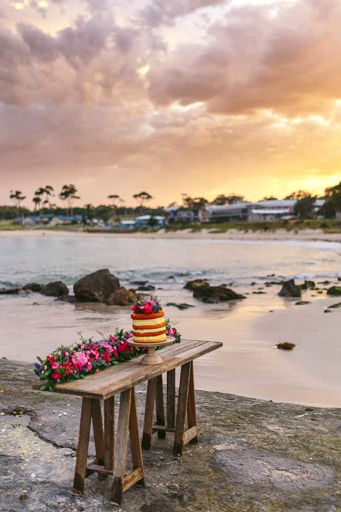 Beach wedding cake at sunset